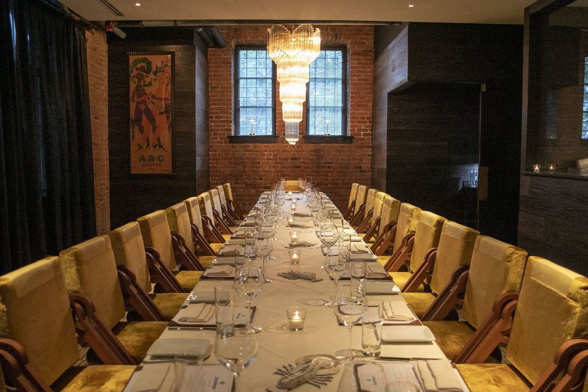 Scampo's private dining room, set with a long table.